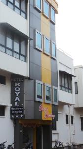 a hotel with a sign on the side of a building at Hotel Royal Residency Executive in Miraj