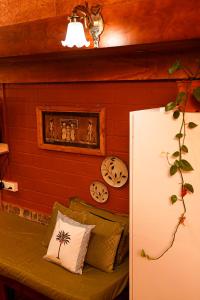 a red brick wall with a couch with pillows at De Rock Jungle Living Resort in Coonoor +94 photos