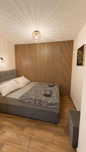 a bedroom with a bed in a room with a wall at Apartament Bielsko in Bielsko-Biała