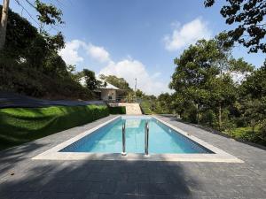 a swimming pool on top of a house at EcoHills in Anachal