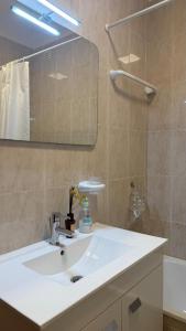 a bathroom with a white sink and a mirror at Casa da Margarida in Castro Marim