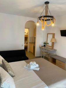 a bedroom with a bed with two towels on it at Astri Hotel in Neos Marmaras