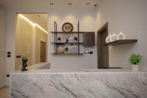 a marble counter in a room with a clock on the wall at weston west in 6th Of October