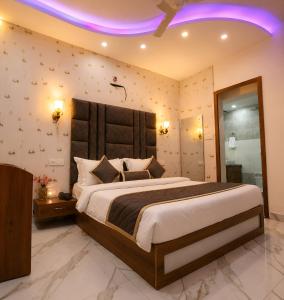 a bedroom with a large bed with a purple ceiling at Hotel KMG Air Cooled,Zirakhpur Chandigarh ,Couple first choice ,verified hotel in Zirakpur