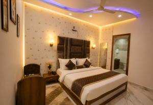 a bedroom with a large bed and a purple light at Hotel KMG Air Cooled,Zirakhpur Chandigarh ,Couple first choice ,verified hotel in Zirakpur