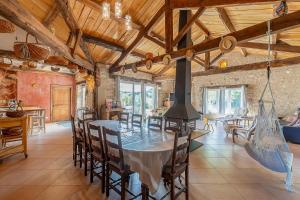 a kitchen and dining room with a table and chairs at Maison de Charme en Pleine Nature in Bournazel
