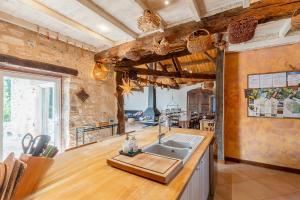 a kitchen with a sink and a counter top at Maison de Charme en Pleine Nature in Bournazel +33 photos