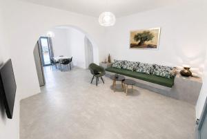 a living room with a couch and a table at Villa Therme Athen - Sea View Jacuzzi Santorini Stay in Emporio +8 photos