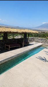 a swimming pool with a table and a picnic table at Eagle Nest lake Natron Lodge in Mtowabaga