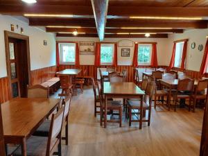 a dining room with wooden tables and chairs at Horská chata U Pekařů in Pec pod Sněžkou +75 photos