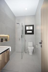 a bathroom with a shower and a toilet and a sink at weston west in 6th Of October +26 photos