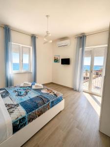 a bedroom with a bed and a view of the ocean at La Finestra Sul Mare in Torretta