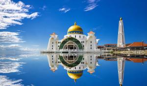 a mosque with its reflection in the water at Atlantis Residences by UVM Stay -4 Pax in Malacca