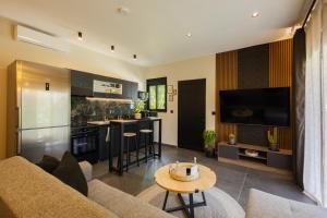 a living room with a couch and a table at Kálos Housing - Adults Only in Kolymbia