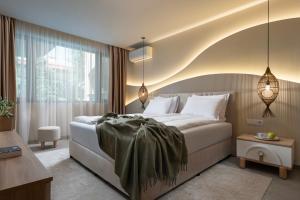 a bedroom with a bed and a large window at Casa Real in Sveti Vlas +75 photos