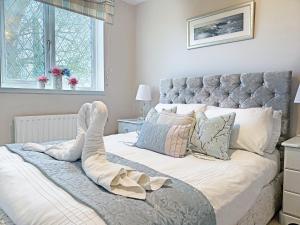a bedroom with a large bed with a large headboard at The Old Barn-E1425 in Addlethorpe +18 photos