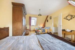 a bedroom with a large bed in a room at La tourelle de la croix in Picauville