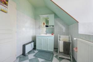 a bathroom with a sink and a mirror at La tourelle de la croix in Picauville +15 photos