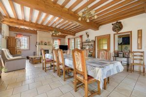 a kitchen and dining room with a table and chairs at La tourelle de la croix in Picauville