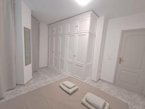 a white room with two towels on a table at Centric 2 bedrooms Apartment near to the beach - newly renovated bathroom and bedrooms - by TENERIFEHINTS in El Médano