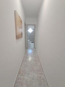 a hallway with white walls and a tile floor at Centric 2 bedrooms Apartment near to the beach - newly renovated bathroom and bedrooms - by TENERIFEHINTS in El Médano