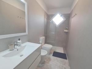 a bathroom with a sink and a toilet and a window at Centric 2 bedrooms Apartment near to the beach - newly renovated bathroom and bedrooms - by TENERIFEHINTS in El Médano