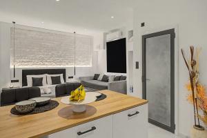 a kitchen with a table and a living room at Doliva Studio 6 with private pool in Agios Gordios