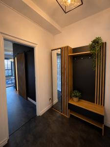 a hallway of a home with a mirror and a plant at Sleep Good by Adria 