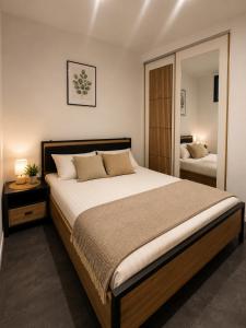 a bedroom with a large bed and a mirror at Sleep Good by Adria 