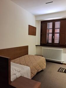 a bedroom with a bed and a window at Domus Laetitiae Assisi in Assisi +56 photos