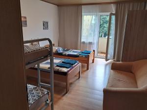 a room with three bunk beds and a couch at Ferienwohnung Andy in Bremerhaven