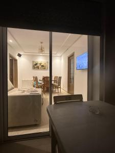 a bedroom with a bed and a dining room at rental per night in Nabeul