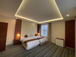 a hotel room with two beds and a large window at نزل خيال جيزان in Jazan +41 photos