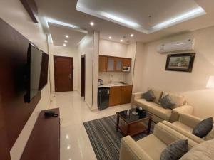 a living room with a couch and a table at نزل خيال جيزان in Jazan