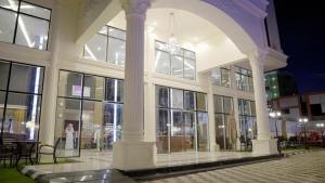 a large building with windows and tables and chairs at نزل خيال جيزان in Jazan