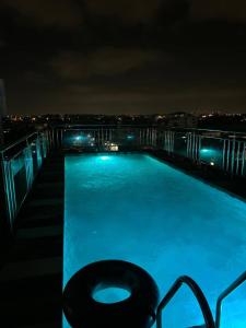 a swimming pool at night on a building at Tchaopremium in Lomé