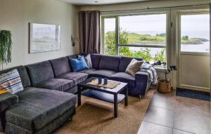 a living room with a couch and a table at Valvik in Tansøy