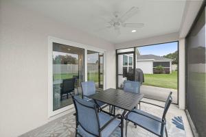 a dining room with a table and chairs at Spacious 3BR - Sleeps 7 - King Bed - Lanai in Okahumpka