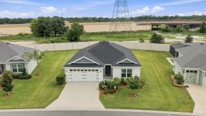 an aerial view of a house with a yard at Spacious 3BR - Sleeps 7 - King Bed - Lanai in Okahumpka