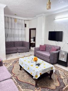 a living room with two couches and a table at بوابة جرش Jarash Gate in Jerash