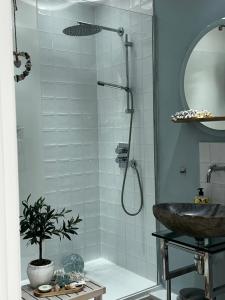 a bathroom with a shower and a sink at Ocean Drive Deluxe Apartment with use of the Day time Beach Hut in Brean +50 photos
