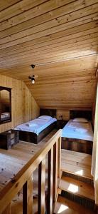 a room with two beds in a wooden cabin at კერა მთაში Kera Mtashi in Ambrolauri