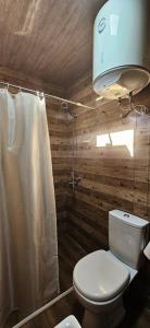 a bathroom with a toilet and a shower at კერა მთაში Kera Mtashi in Ambrolauri