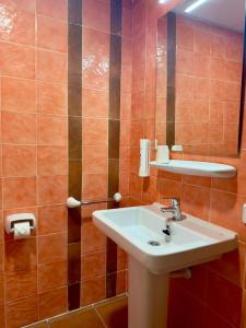 a bathroom with a sink and a mirror at Hotel Casa Manolet 