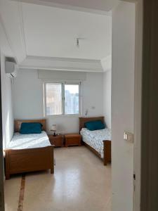 a bedroom with two beds and a window at Dar El vague in Hiboun