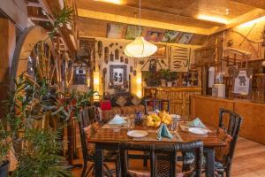 a dining room with a wooden table and chairs at De Rock Jungle Living Resort in Coonoor