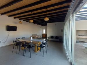 a dining room with a table and chairs at Quincho Lelita in Zonda