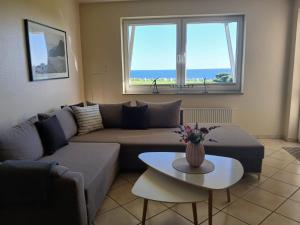 a living room with a couch and a table at Meeresrauschen in Fehmarn