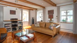 a living room with a couch and a table at Exklusives Gut Stohrerhof am See in Dießen am Ammersee
