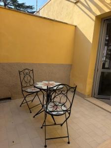 two chairs and a table on a patio at Casina Toscana in Certaldo